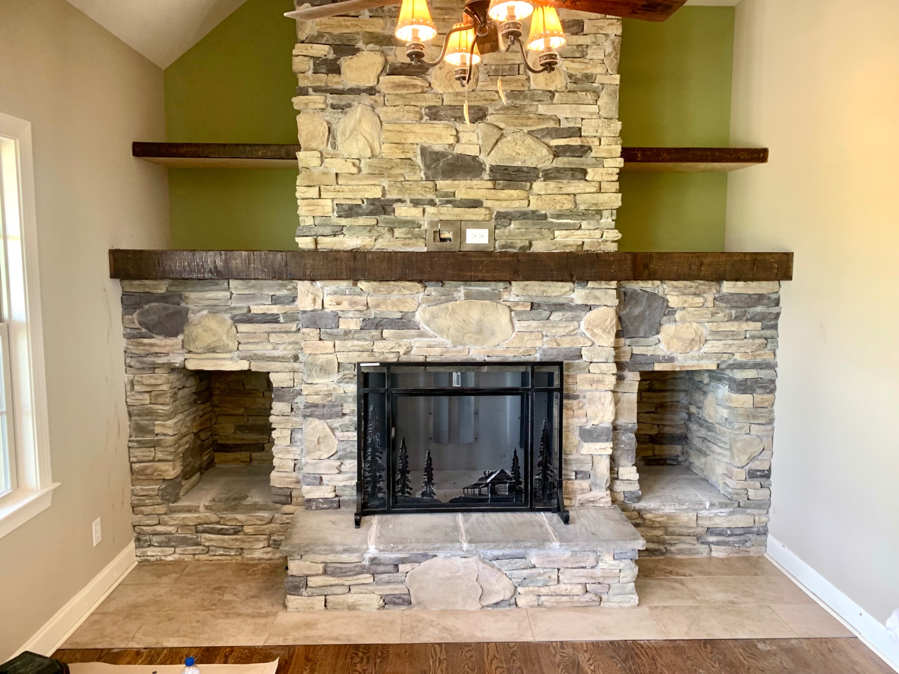 Floor-to-ceiling stacked stone fireplace