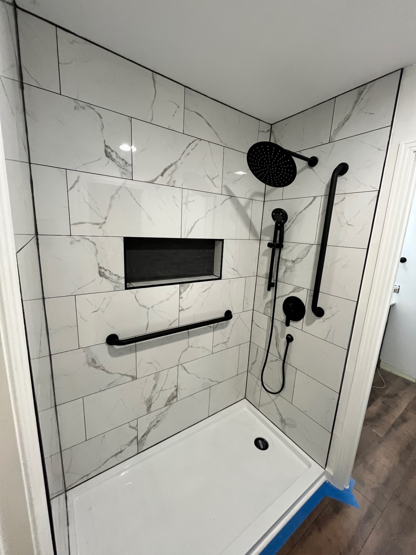 Marble tile shower with matte black fixtures