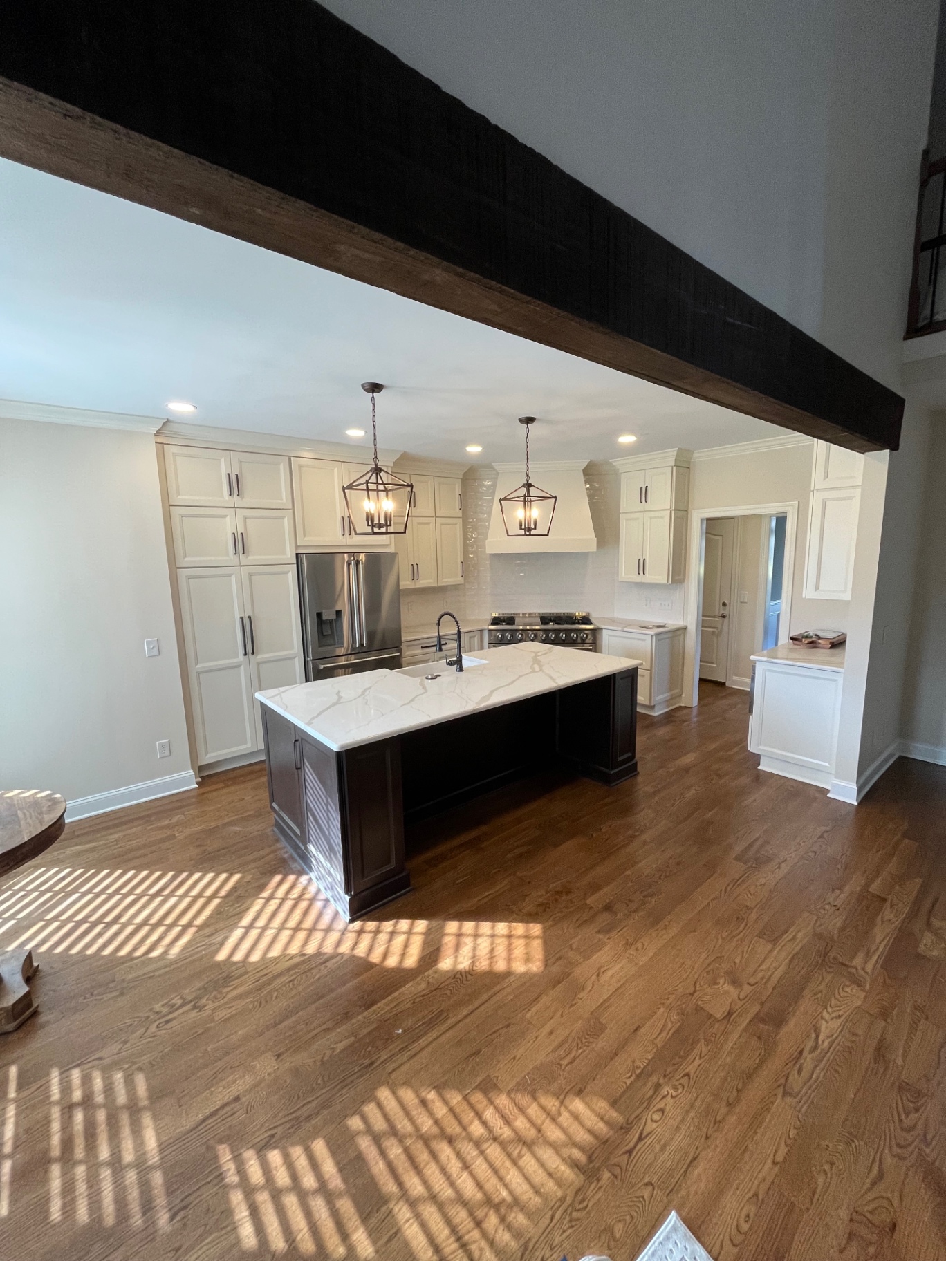 Open kitchen with reclaimed beam and island