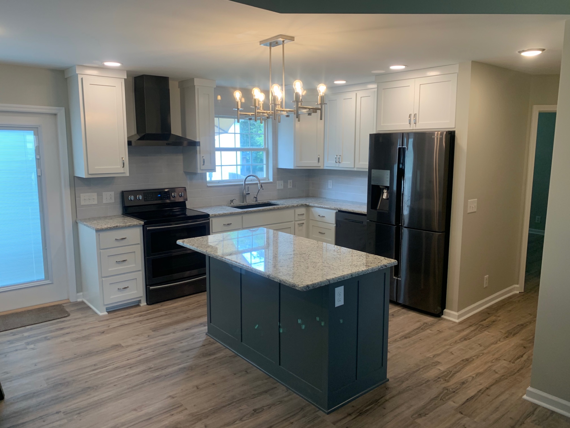 Two-tone kitchen with teal island
